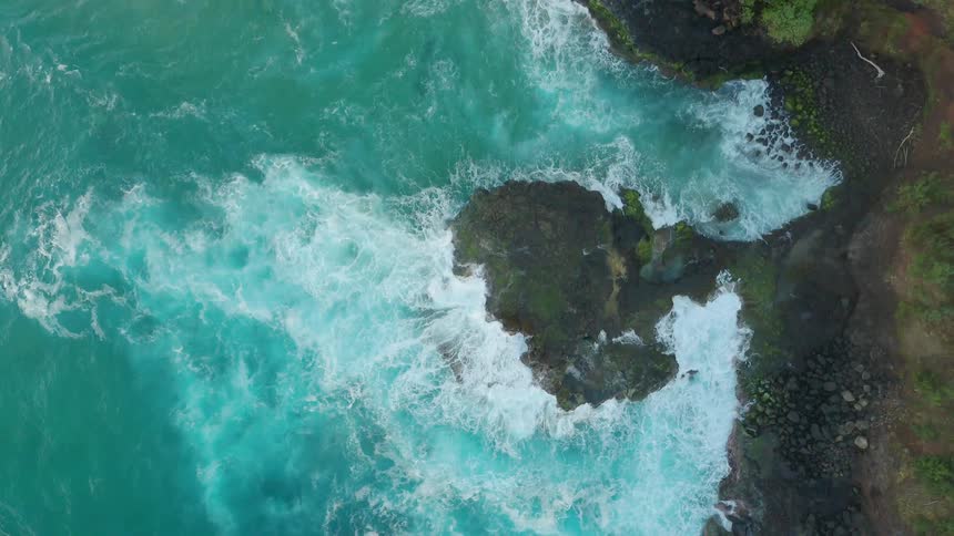 Ocean waves crash into a shore