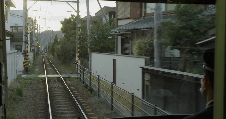 A train is travelling through a neighborhood