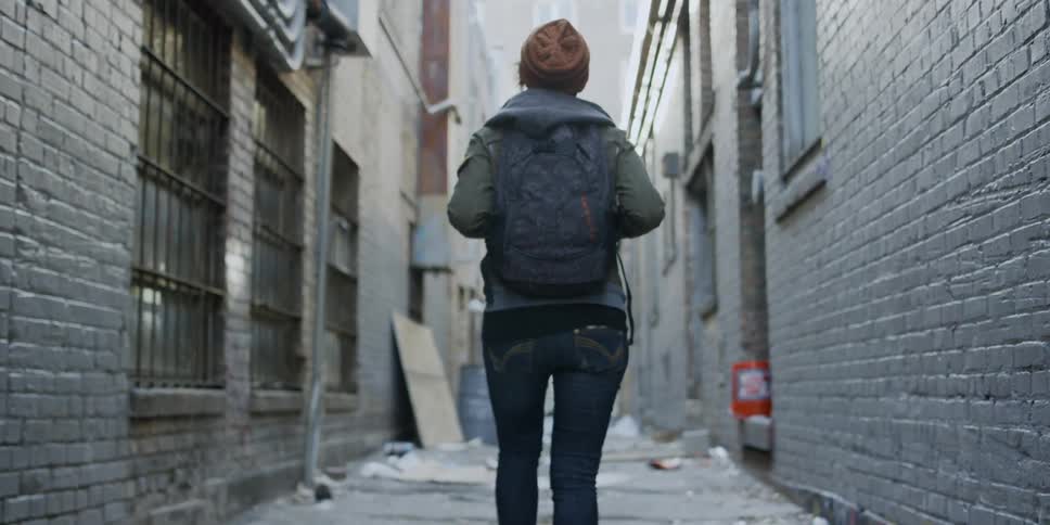 Woman walks in a city alley