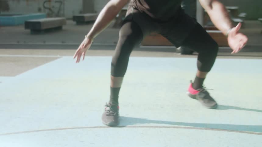 Man plays basketball on an outdoor court