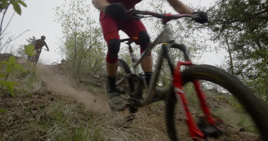 People ride bikes down a steep hill