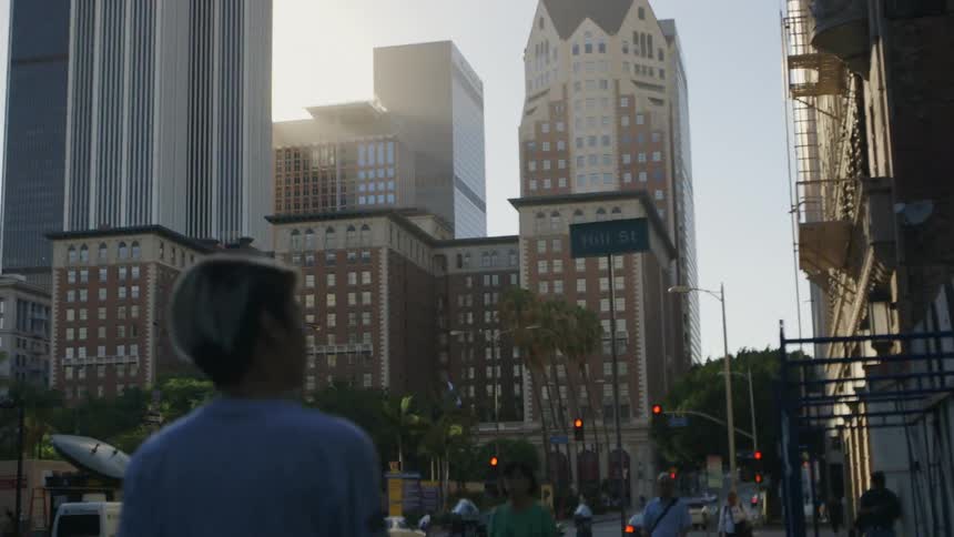 People walking down a busy street with buildings