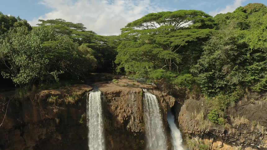 Three waterfalls splashing down off a cliff