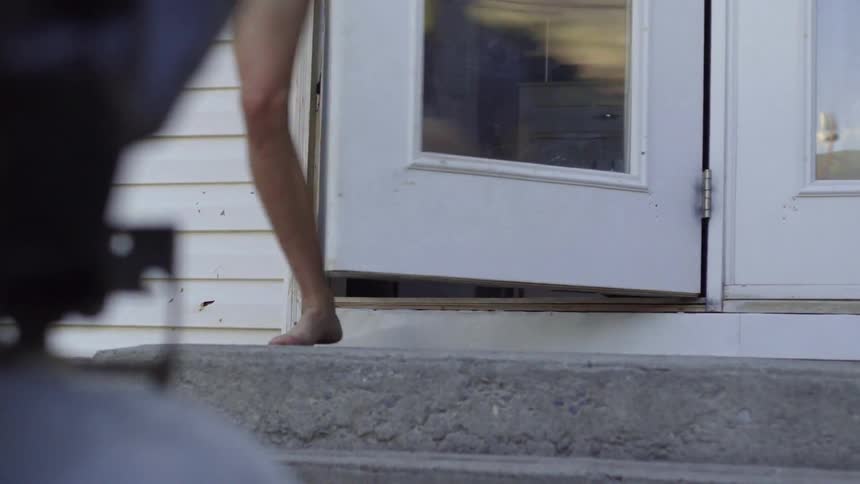 A door opening and a view of a young woman's legs as she runs out
