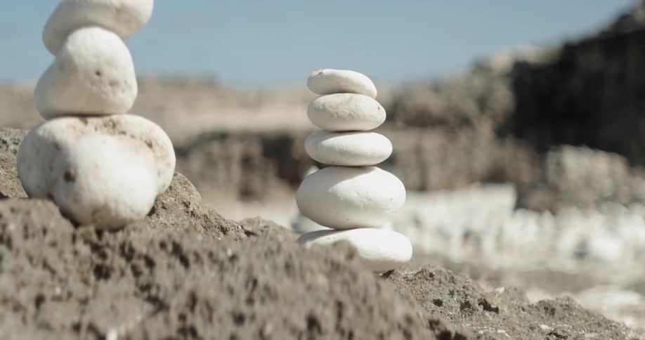 White stones in a pile sit on the dirt