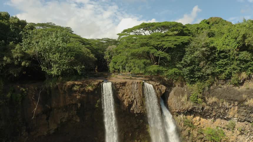Waterfalls flow over a cliff