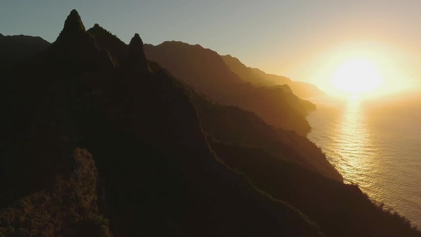 The sun sets over a coastline