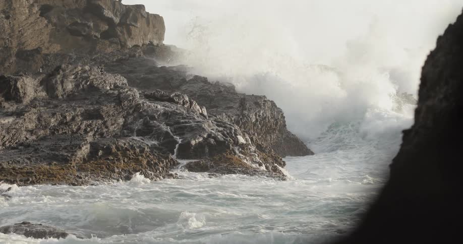 Ocean waves crash into rocks