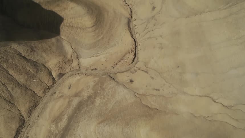 Shadows over sandy hilly desert