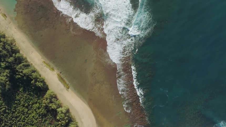 Ocean waves wash ashore a sandy beach