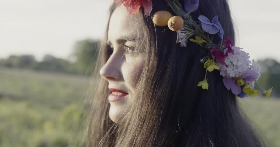 A woman is wearing a flower headdress