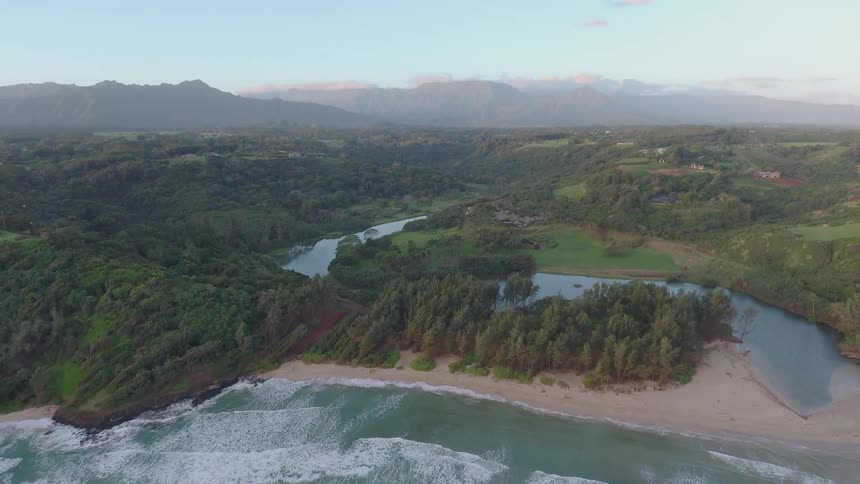 Waves are rolling onto a beach during the day