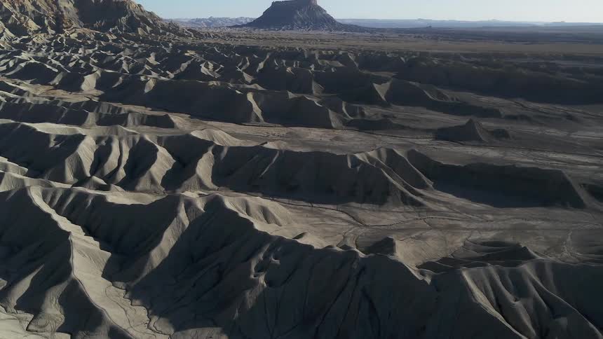 Rocky crags are shown next to a large mountain