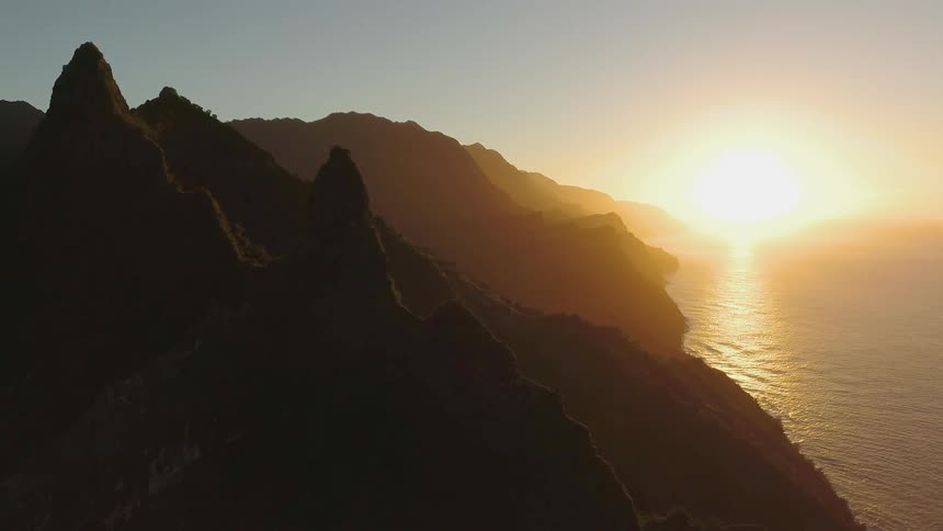 The sun sets over a coastline