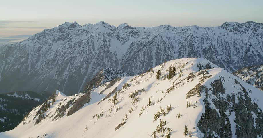 Snow covers mountains at sunset