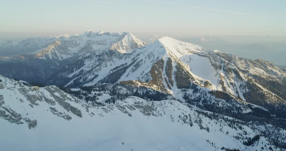 Snow covers mountains at sunset