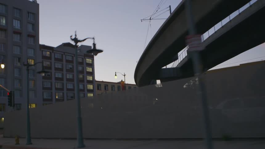 Driving down a city street at sunset
