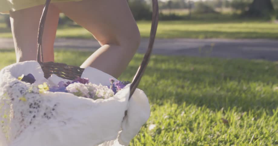 Woman carries a basket of flowers