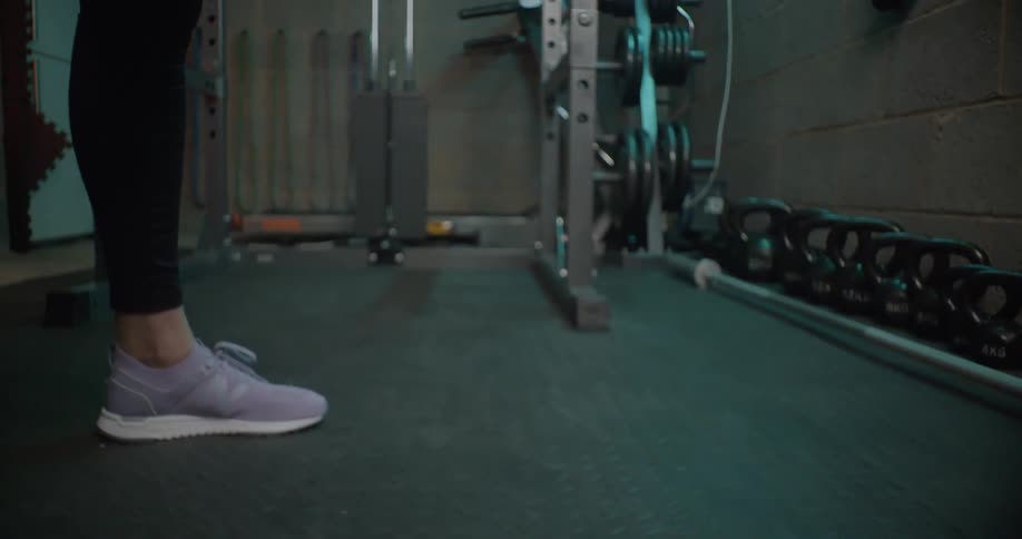 A woman exercises in a home gym