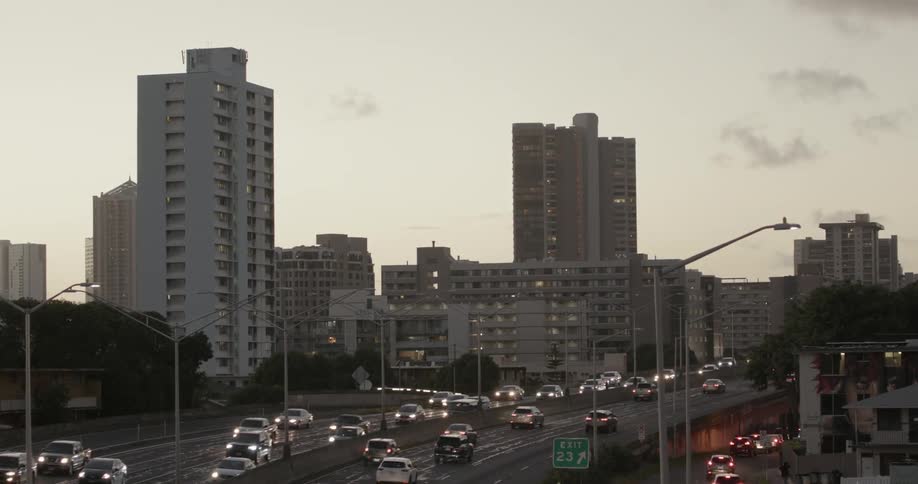 A busy interstate next to tall buildings