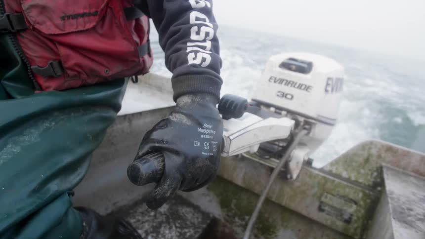 Person steers a small boat