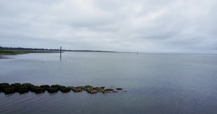 Calm lake sits under a cloudy sky
