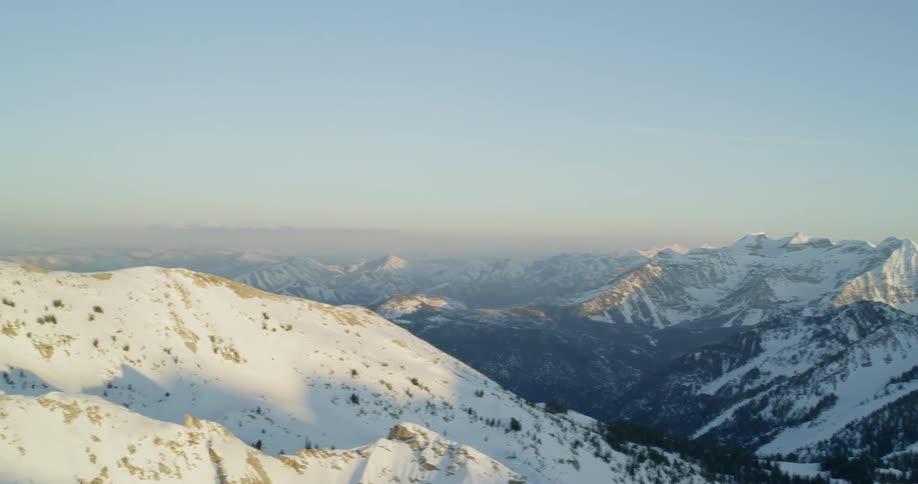 Bright sun shines on snow covered mountains