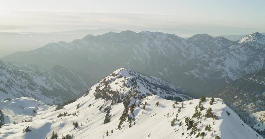 Snow covers mountains at sunset