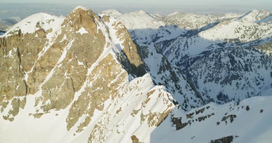 Snow covered mountains sit under a blue sky