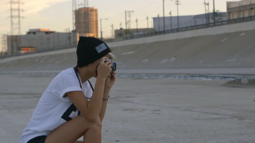 Person crouching taking some photographs