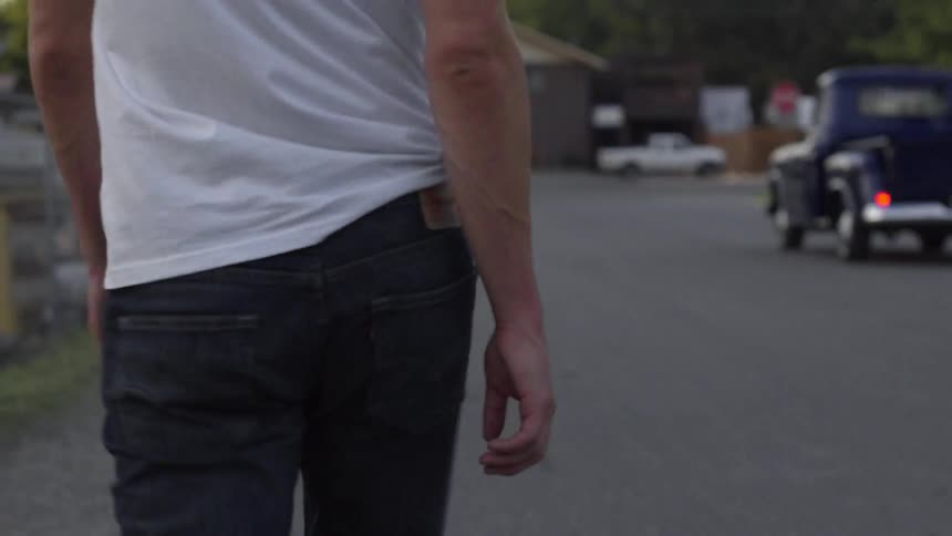 View of a man's behind as he walks down the street