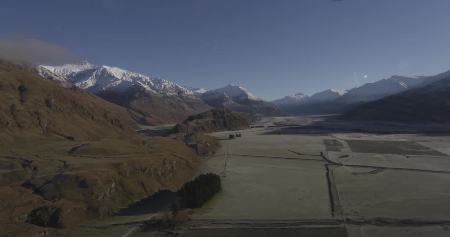 The long fields lead to the mountains