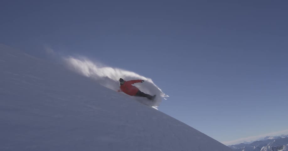 A man snowboarding down a mountain