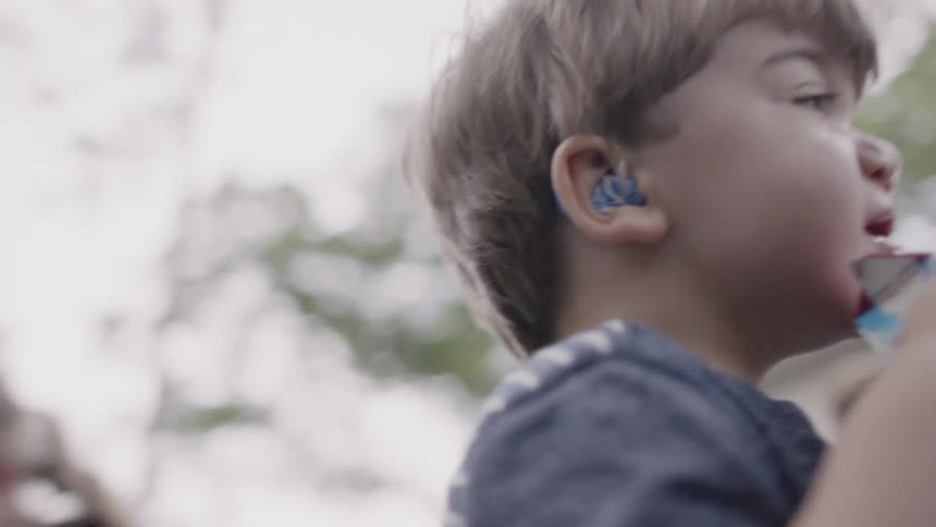 Young boy drinks juice in a backyard