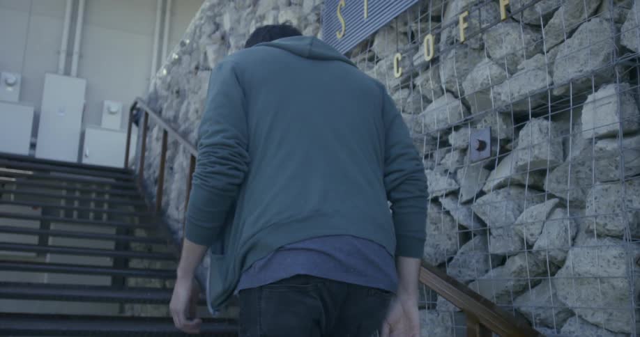 Man walks up outdoor stairs