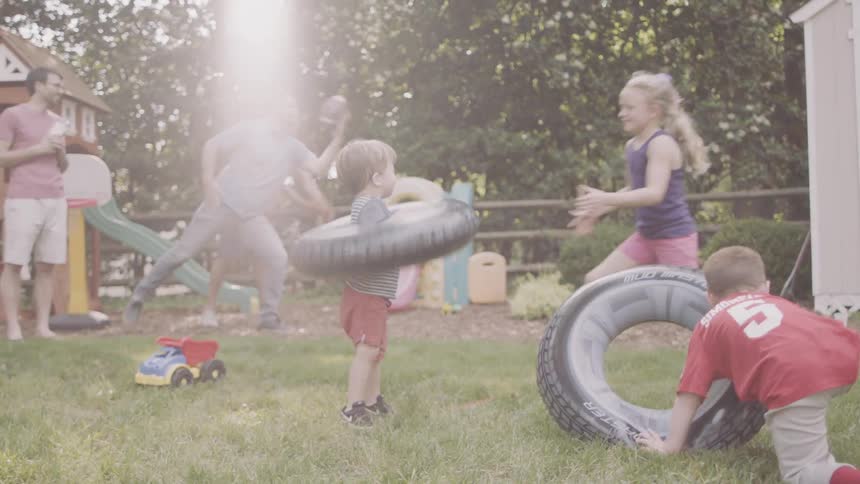 Young children play in a backyard