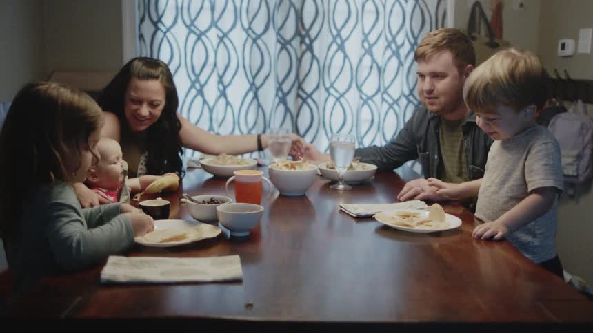 A family eats at a dining table