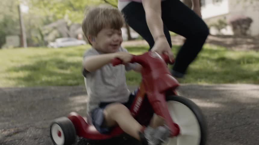 Toddler boy rides a tricycle