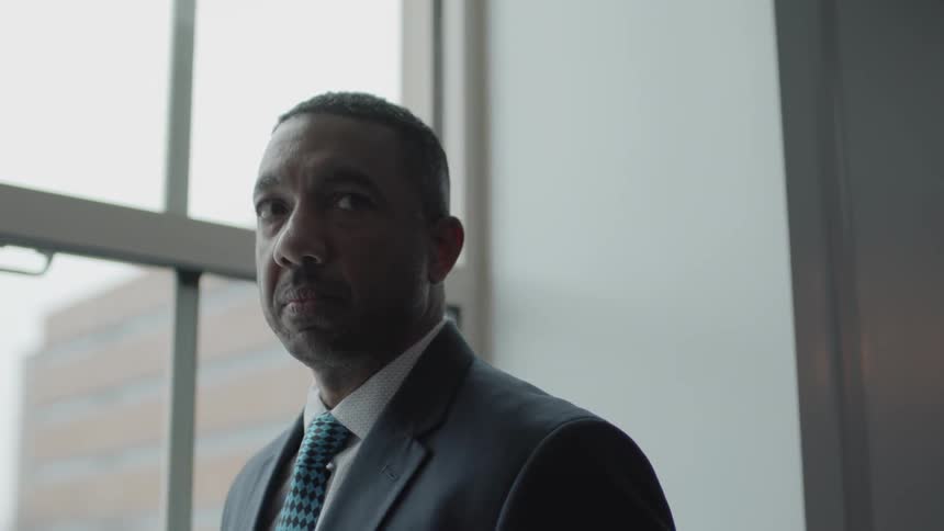 Man dressed in a suit near a window