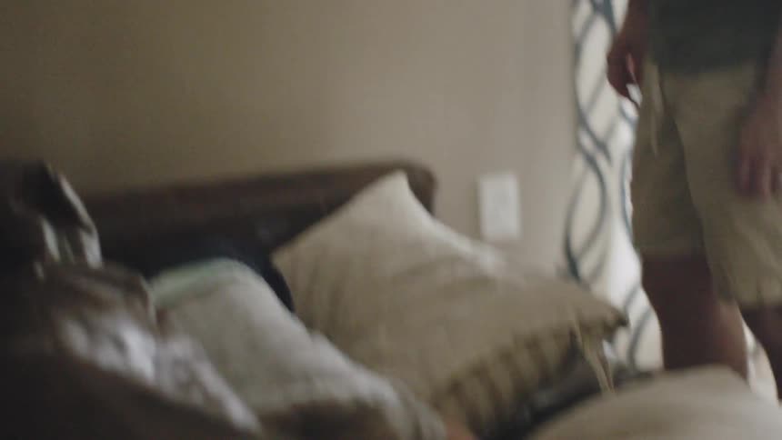 Young boy jumps on a couch