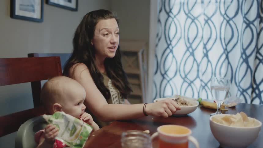 Family talks and eats at a dining room table