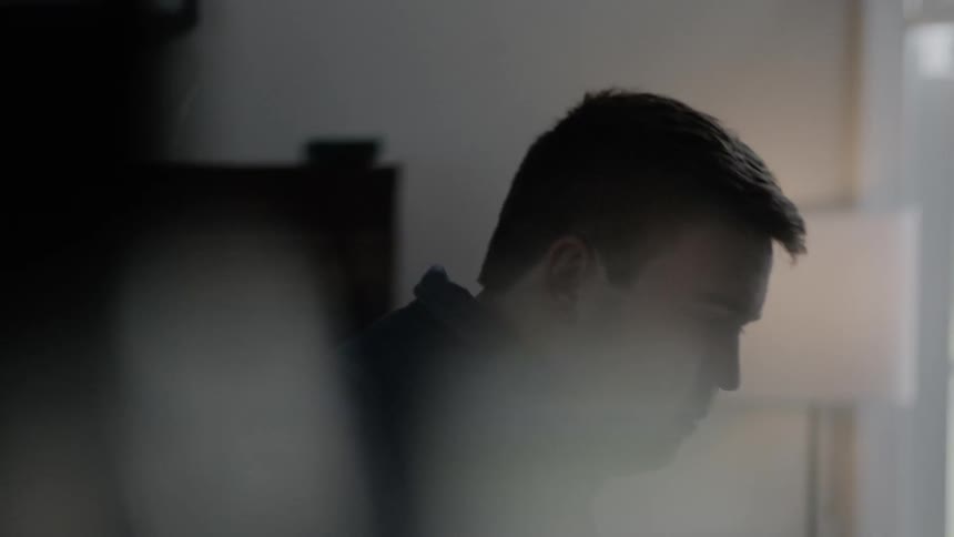 A man bows his head