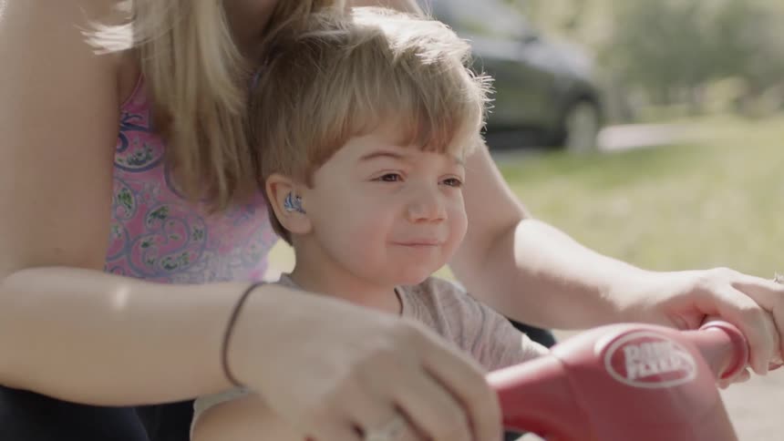 Toddler boy rides a tricycle