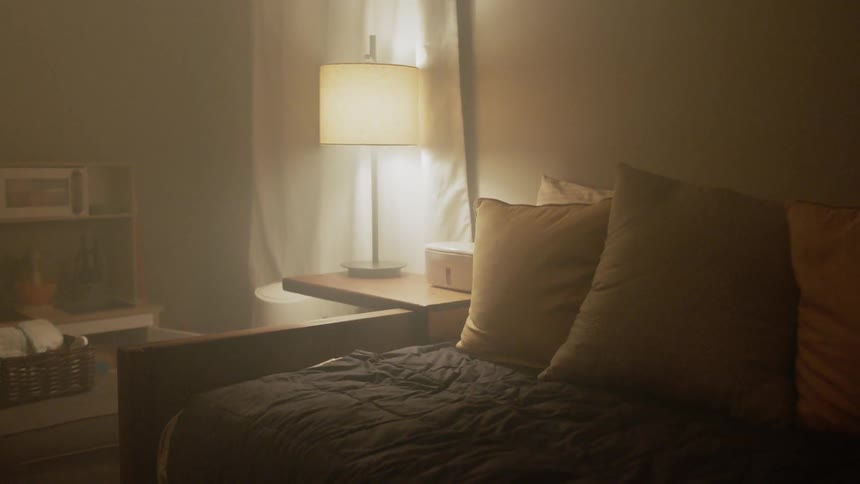 Lamp illuminates an empty bedroom