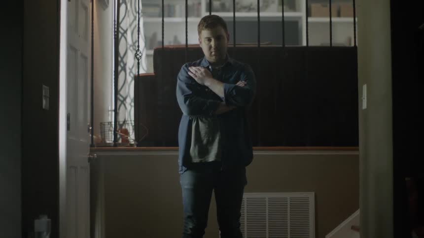 Someone is standing in the hallway with their arms crossed