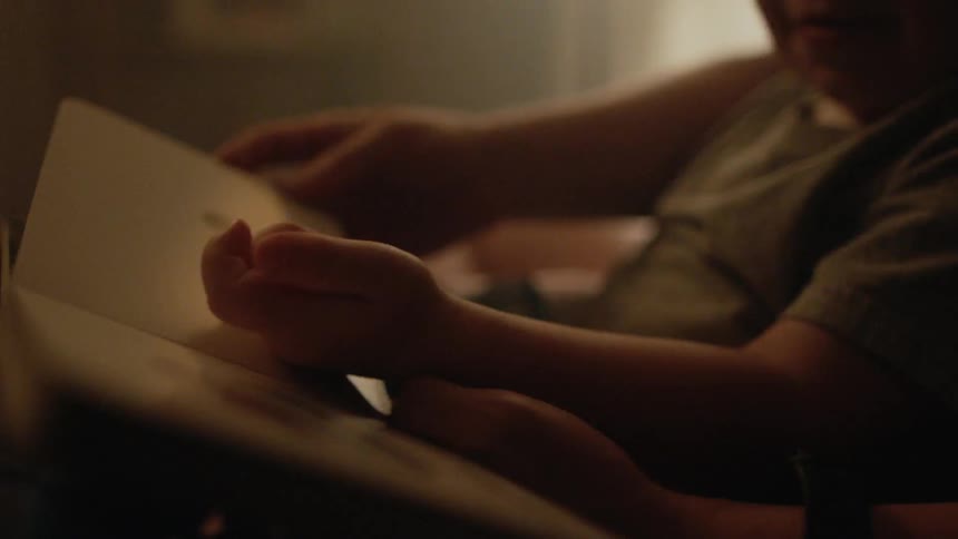 Mother and son read books at home