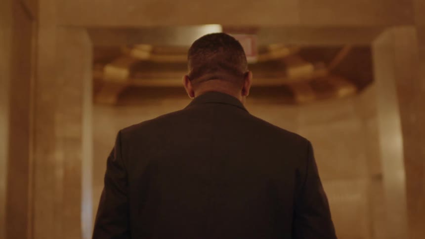 Man walks in the hallway of a building
