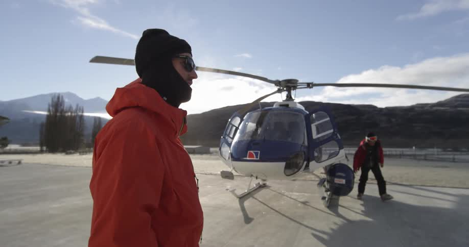 People standing on a pad next to a helicopter