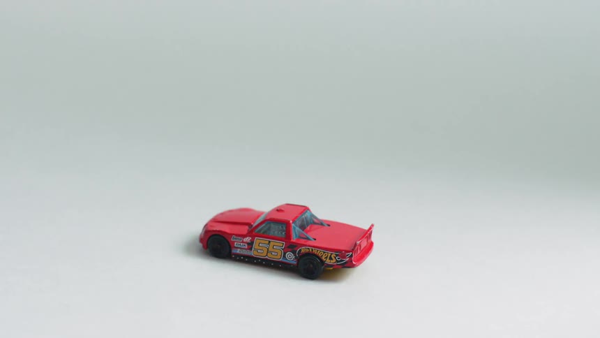 A toy car sit on the floor