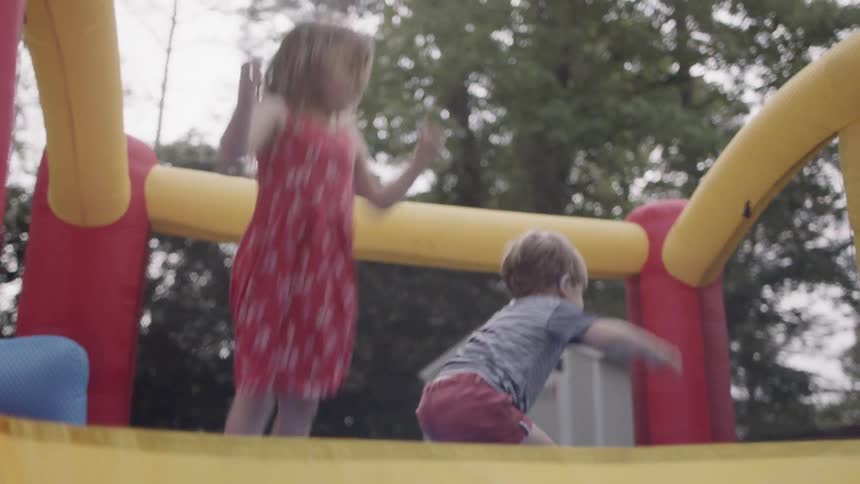 Children jump up and down on a bouncy castle